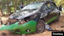 A car is left smashed in Lilongwe, Malawi, on Feb. 24, 2024, after an armed group attacked supporters of the nation's main opposition party.