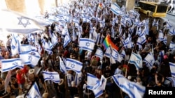 People demonstrate as a response to Israeli Prime Minister Benjamin Netanyahu and his nationalist coalition government's judicial overhaul, at Ben Gurion International Airport in Lod, Israel, July 11, 2023. 