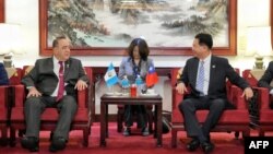 Guatemala's President Alejandro Giammattei, left, meets with Taiwan Foreign Minister Joseph Wu after his arrival to Taoyuan International Airport, in Taoyuan, Taiwan, April 23, 2023. (Taiwan Ministry of Foreign Affairs/Handout via AFP)