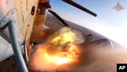 In this photo taken from video released by the Russian Defense Ministry Press Service on Dec. 13, 2023, a Ka-52 helicopter gunship of the Russian air force purportedly fires rockets at a target at an unidentified location in Ukraine.