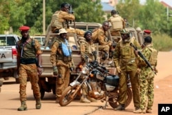 FILE - Soldiers loyal to Burkina Faso's latest coup leader, Capt. Ibrahim Traore, are pictured in Ouagadougou, Oct. 14, 2022. Human rights groups have documented cases of what they call war crimes against civilians in the conflict in Africa’s Sahel.