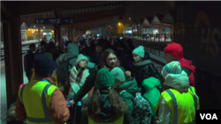 红十字会志愿者监督和照管准备乘火车前往德国的乌克兰难民。