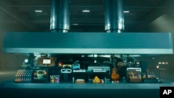 In this image taken from a video advertisement, a hydraulic press crushes an array of creative instruments. The newly released ad promoting Apple's new iPad Pro has struck quite a nerve online.