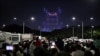 People watch drones' formation flying at the World Drone Light Show 2024, which is a part of the 2024 Korea Drone Expo, in Incheon, South Korea, May 9, 2024. 
