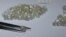 FILE - Diamonds are displayed during a visit to the De Beers Global Sightholder Sales (GSS) in Gaborone, Botswana, Nov. 24, 2015. 