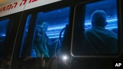 FILE - Mia Schem, 21, who was released after 55 days in Hamas captivity in Gaza, is seen in a convoy near Ofakim, Israel, Nov. 30, 2023.