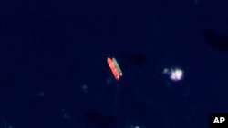 FILE - In this satellite photo provided by Planet Labs PBC, vessels identified as the Virgo, left, and the Suez Rajan by the advocacy group United Against Nuclear Iran are seen in the South China Sea on Feb. 13, 2022. 