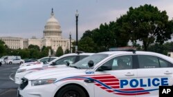 FILE - Washington Metropolitan Police Department vehicles are pictured on the perimeter of the Capitol, Aug. 26, 2021. 