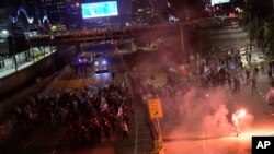 Demonstrators block a highway during a protest against plans by Prime Minister Benjamin Netanyahu's government to overhaul the judicial system in Tel Aviv, Israel, March 25, 2023.
