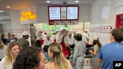 Customers queue up to order at an In-N-Out restaurant Sunday, June 2, 2024, in Lone Tree, Colo. On Wednesday, June 12, 2024, the Labor Department issues its report on prices at the consumer level in May. 
