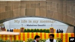 Officials wait for the arrival of the G20 leaders to pay their respects at the Rajghat, Mahatma Gandhi memorial, in New Delhi, India, Sept. 10, 2023.
