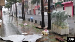 Scattered debris litters a downtown street as high winds brought by Typhoon Khanun hit the city of Naha, Okinawa prefecture, Japan, Aug. 2, 2023.