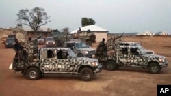 In this screen grab taken from video, Nigerian Army vehicles are parked at the village where children were kidnapped in Kuriga, Kaduna state, March 7, 2024. 