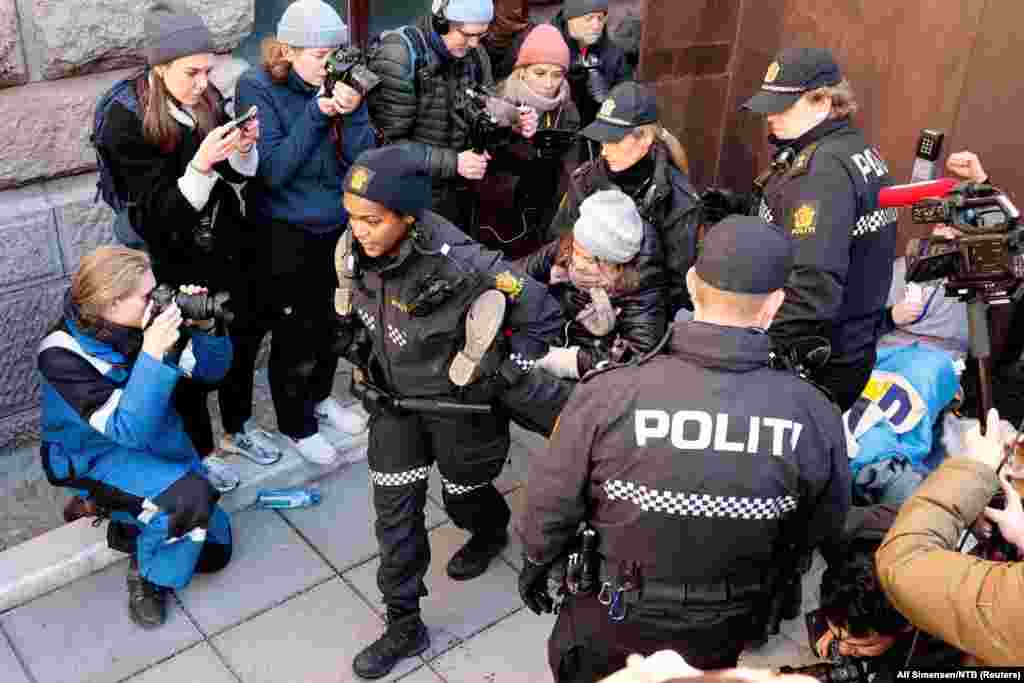 Norweigean police carry away Greta Thunberg as activists demonstrate outside the Ministry of Finance entrance and several other ministries in Oslo, Norway, March 1, 2023, in protest that the wind turbines at Fosen, have not been demolished. 