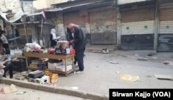 A man browses through products at a stall on the Syrian government-controlled side of Palestine Street in Hasaka, Syria, March 22, 2024.