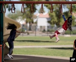 FILE - Elementary school students play on the last day of classes at Frye Elementary School in Chandler, Arizona work on their end of the year digest Tuesday, May 23, 2023.(AP Photo/Darryl Webb)