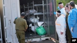 Bodies of Israelis killed in an unprecedented Hamas attack are stored for identification, at a military base in Ramla, Israel, Oct. 13, 2023.