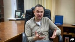 Vadym Guttsait, Ukraine's Youth and Sport Minister and President of the National Olympic Committee of Ukraine, talks during an interview with The Associated Press in Kyiv, Ukraine, Feb. 14, 2023. 