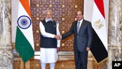 Egyptian President Abdel-Fattah el-Sissi, right, shakes hands with India Prime Minister Narendra Modi in Cairo, Egypt, June 25, 2023.