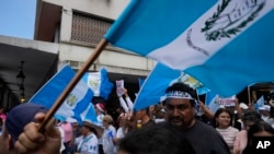 People march against legal actions taken by the Attorney General's office against the Seed Movement party and President-Elect Bernardo Arévalo, in Guatemala City, Sept. 2, 2023. 