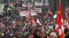 Unions and people demonstrate in Bayonne, southwestern France, March 7, 2023. Garbage collectors, utility workers and train drivers are among people walking off the job across France to show their anger at a bill raising the retirement age to 64.
