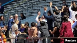 President Joe Biden waves as members of the crowd snap photos of him and his family as they attend the University of Pennsylvania graduation ceremony where granddaughter Maisy Biden received her degree in Philadelphia, May 15, 2023.