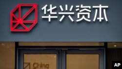 Logo dari lembaga finansial terkemuka China Renaissance terpasang di gedung kantor perusahaan perusahaan tersebut di Beijing, pada 17 Februari 2023. (Foto: AP/Mark Schiefelbein)