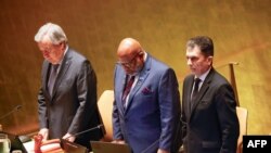 U.N. Secretary-General António Guterres, left, stands during a moment of silence during a United Nations General Assembly tribute to the late Iranian President Ebrahim Raisi at U.N. headquarters in New York on May 30, 2024. (KENA BETANCUR / AFP)