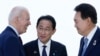 FILE - President Joe Biden talks with Japan's Prime Minister Fumio Kishida and South Korean President Yoon Suk Yeol, right, ahead of a trilateral meeting on the sidelines of the G7 Summit in Hiroshima, Japan, May 21, 2023. 