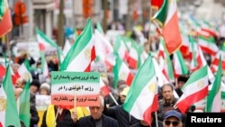 Supporters of the National Council of Resistance of Iran (NCRI) take part in a protest, in Brussels, Belgium, March 20, 2023. European ministers agreed to add eight Iranians and one of the Tehran government's most powerful bodies to EU sanctions lists.