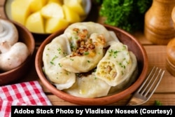 FILE- Potato mushroom stuffed vareniky, pierogi or dumplings. (Adobe Stock Photo by Vladislav Noseek)