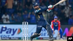 FILE - Gujarat Titans' Rashid Khan plays a shot during the Indian Premier League cricket match between Delhi Capitals and Gujarat Titans in New Delhi, India, April 24, 2024.