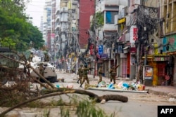 Bangladeshi soldiers patrol the streets to disperse the anti-quota protesters in Dhaka on July 20, 2024.