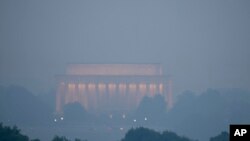 Haze blankets the Lincoln Memorial on the National Mall in Washington, June 8, 2023, as seen from Arlington, Va.