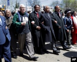 FILE - From L; Rev. James Lawson, labor union leader Lee Saunders, Bishop Charles E. Blake Sr., Rev. Al Sharpton, and Martin Luther King III join a march in commemoration of the 50th anniversary of the assassination of Rev. Martin Luther King Jr., April 4, 2018, in Memphis, Tenn.