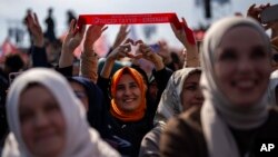 Justice and Development Party (AKP) supporters listen to party leader Recep Tayyip Erdogan, Turkey's president, during a campaign rally ahead of nationwide municipality elections, in Istanbul, March 24, 2024.