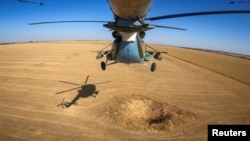 A Ukrainian military Mi-8 helicopter flies in the sky in an undisclosed location in Eastern Ukraine, Sept. 29, 2023, in a screen grab taken from video.