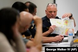 Knoxville Deputy Police Chief Tony Willis uses a map to show the concentration of gun violence crimes during a meeting of the Violence Reduction Leadership Committee on Thursday, Aug. 3, 2023, in Knoxville, Tenn. (AP Photo/George Walker IV)