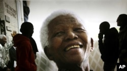 FILE — A photo of former South African President Nelson Mandela on display at the Nelson Mandela Legacy Exhibition in Cape Town, South Africa, on June 27, 2013. 