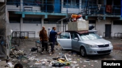 Displaced Palestinians sheltering in a school prepare to flee Rafah, May 13, 2024.