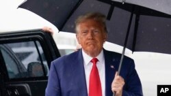 Former President Donald Trump walks to speak with reporters before he boards his plane at Ronald Reagan Washington National Airport, Aug. 3, 2023, in Arlington, Virginia, after facing a judge on federal conspiracy charges.