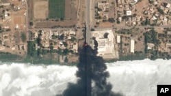 This satellite photo by Planet Labs PBC shows fires burning near a hospital in Khartoum, Sudan, April 16, 2023. 