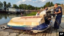 This photo provided by BRFK Facebook shows a damaged boat at the northern edge of Budapest where it was towed, after being discovered in the water by police following a boat collision on the Danube River, in Hungary, May 19, 2024. 