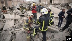 First response officers inspect the damage after a Russian air attack in Kyiv, Ukraine, March 25, 2024.