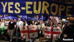 People take part in a protest against a bill on "foreign agents," in Tbilisi, Georgia, April 28, 2024.