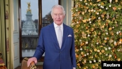 FILE - Britain's King Charles poses for a photo during the recording of his Christmas message at Buckingham Palace, in London, Dec. 7, 2023. 