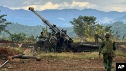 FILE - In this photo provided by the Kokang online media, members of an ethnic armed forces group check weapons the group allegedly seized from Myanmar's army outpost on a hill in Hsenwi township in Shan state, Myanmar, Nov. 24, 2023.