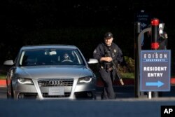 Cobb County Police search cars as they leave the Edison Apartments in Smyrna, Georgia, May 3, 2023, after a shooter killed one person and injured four others in a medical building in Atlanta, then was seen on a traffic camera in the area.