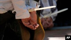 Protesters are cuffed after being detained on the campus of Emory University during a pro-Palestinian demonstration April 25, 2024, in Atlanta.
