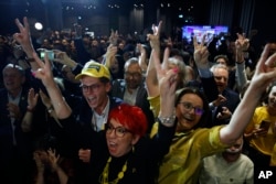 Supporters of the Third Way, a coalition of the centrist Poland 2050 party and the agrarian Polish People's Party celebrate at the electoral headquarters in Warsaw, Oct. 15, 2023.